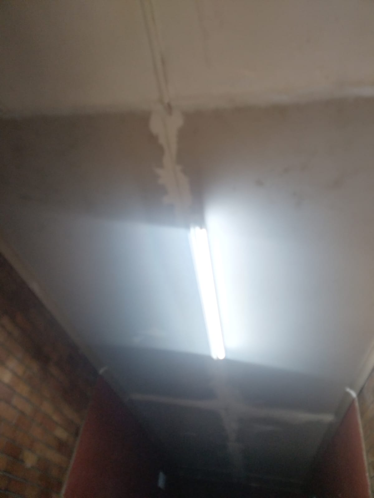 Ceiling repair and painting work in progress with new light fitting
