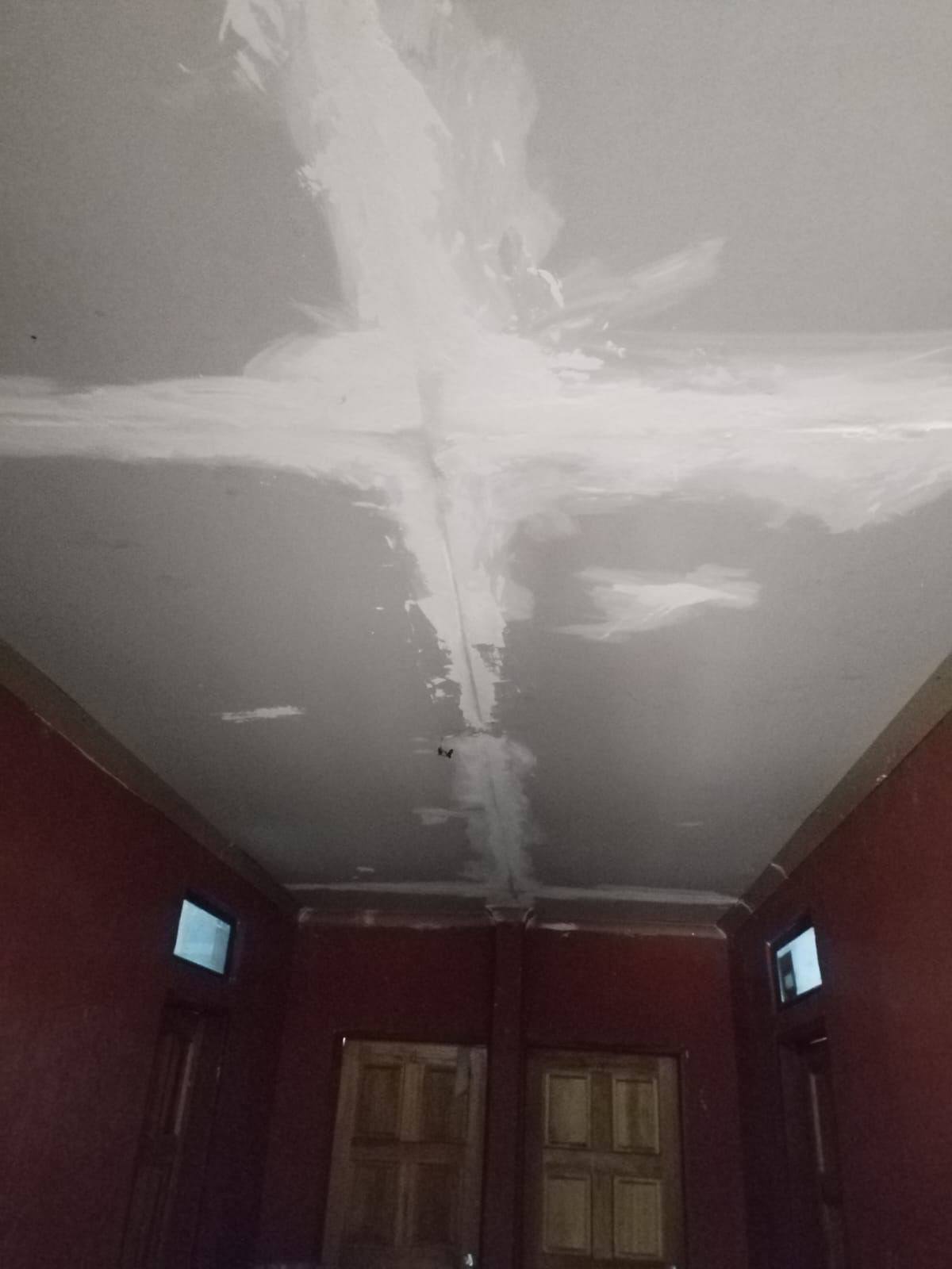 Ceiling being painted and refinished in a residential room