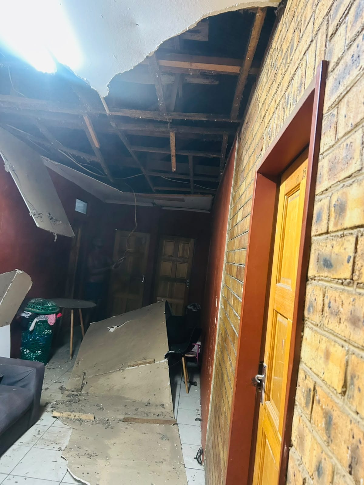 Room with damaged ceiling boards removed for repair and replacement