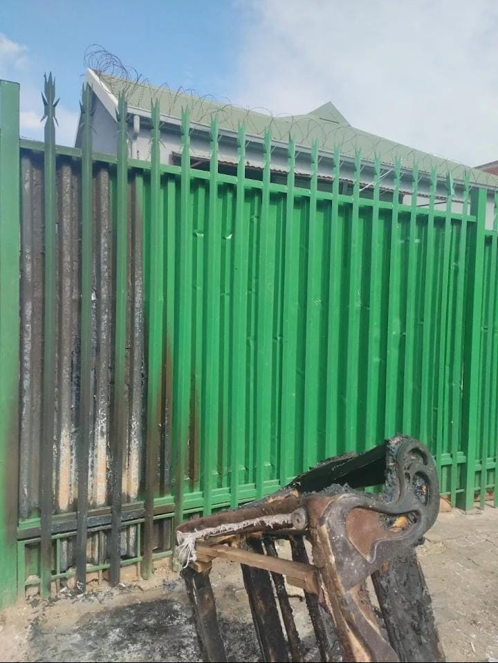 Exterior palisade fence freshly painted green after site clean-up